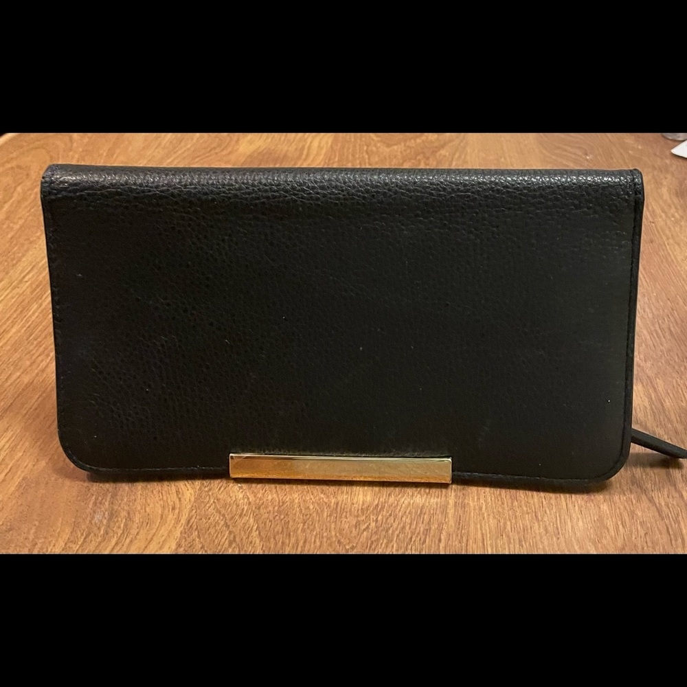 Vince Camuto Wallet. New! Never used. Slight scratches on gold metal bar.